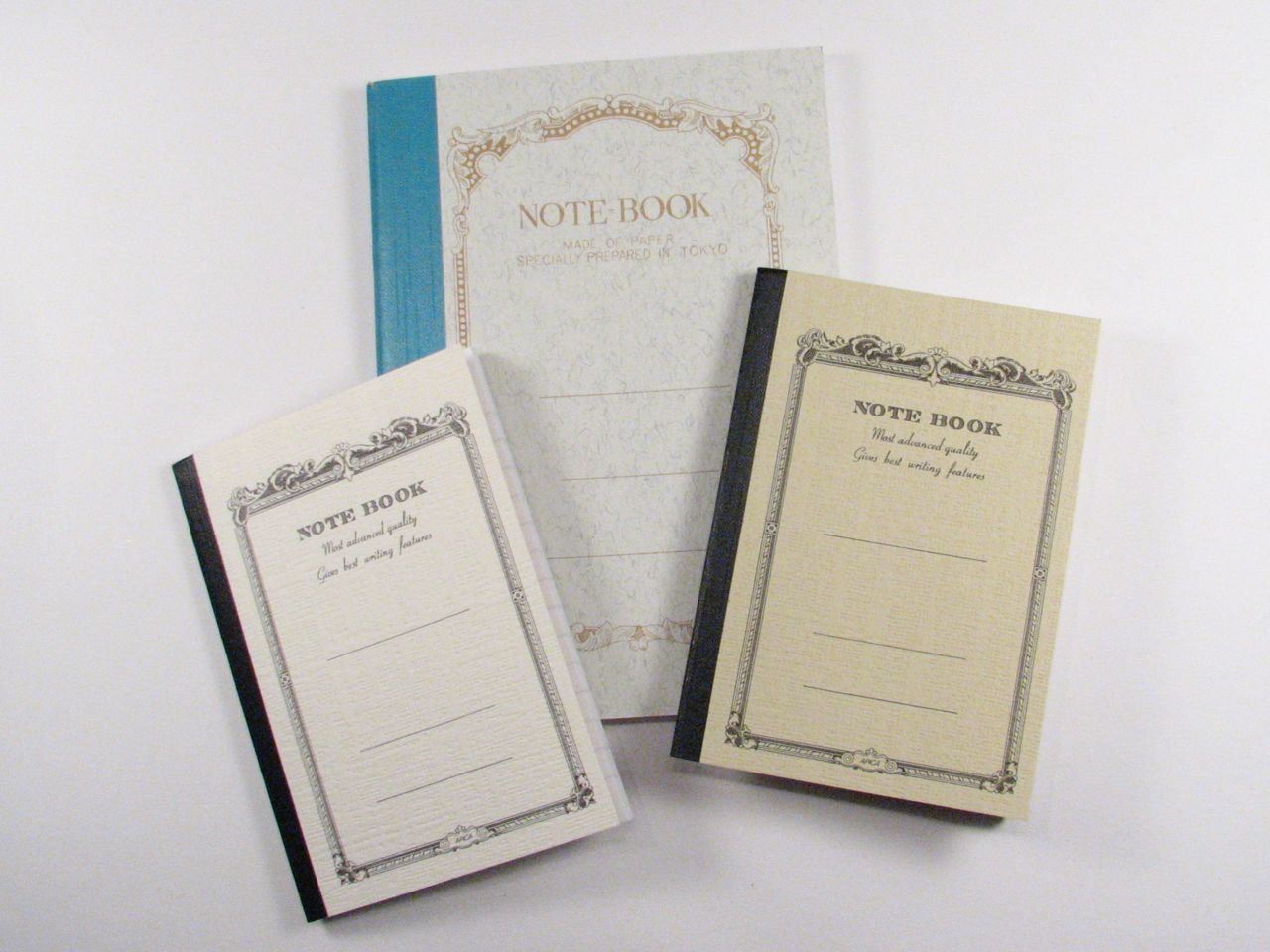 Three hardbound notebooks with gilt-bordered covers marked "NOTE BOOK, made of paper specially prepared in Tokyo", 2010