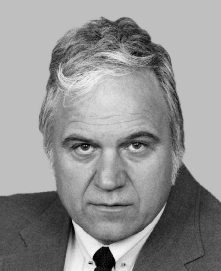 James Traficant in a black-and-white official portrait, wave of grey hair over a grey suit and dark tie, 1990