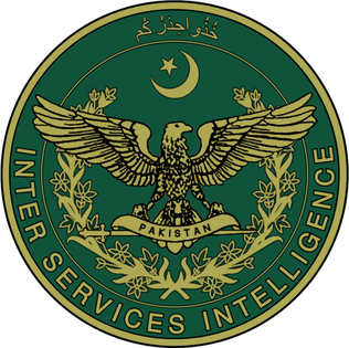 The seal of Inter-Services Intelligence, a gold eagle over a Pakistan-labelled shield inside a laurel wreath on a dark green disc topped by Urdu script, 1948