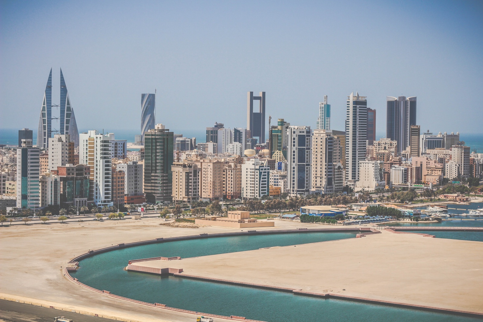 The Manama skyline over reclaimed land and a lagoon on the Bahraini coast, twin-sailed World Trade Center at left, 2015