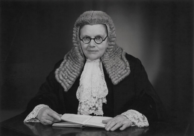 A British barrister in horsehair wig and robes with an open book on the desk, 1950