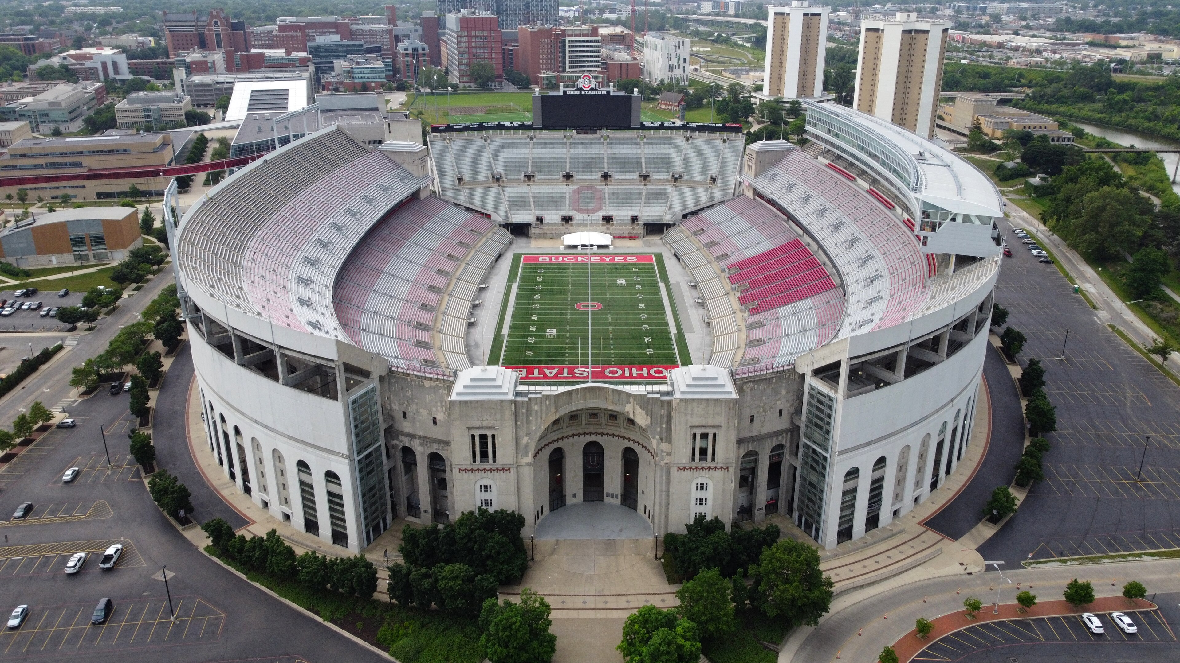Aerial view of Ohio Stadium at midday, red-and-grey seats ringing the Buckeyes field with the Columbus campus behind, 2015