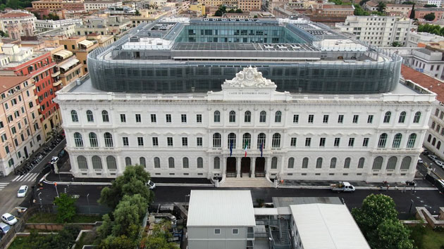 Aerial view of the Cassa di Risparmio building in Rome, neoclassical white palazzo capped by a modern glass extension, 2020
