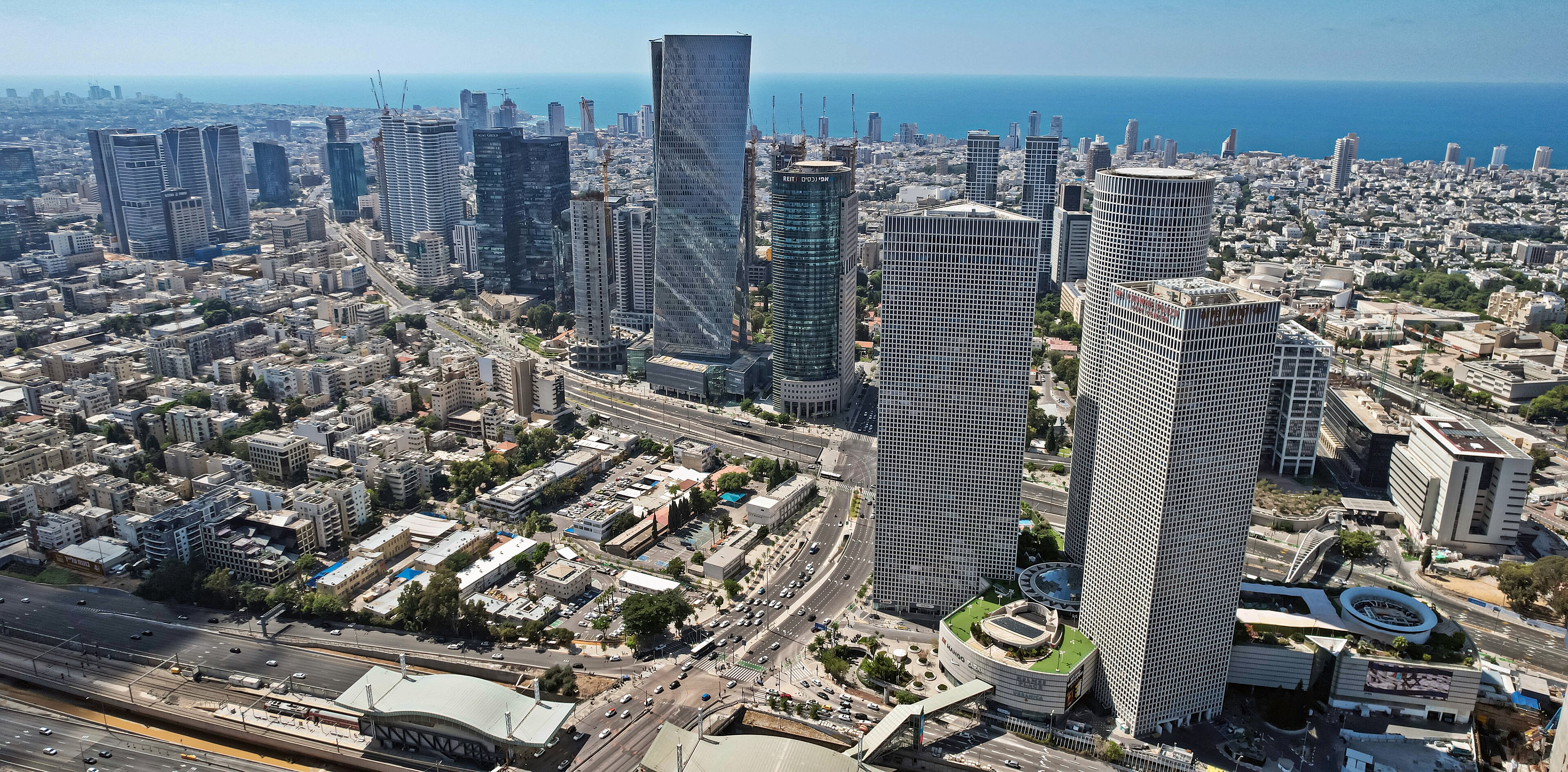 Aerial view of the Tel Aviv central business district, glass towers along Ayalon with the Mediterranean beyond, 2023