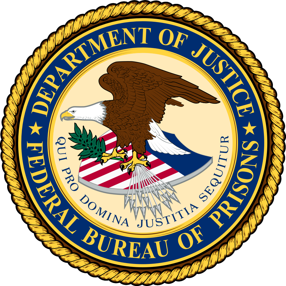 The seal of the Federal Bureau of Prisons, bald eagle over the Justice Department shield above the motto Qui Pro Domina Justitia Sequitur, 1930