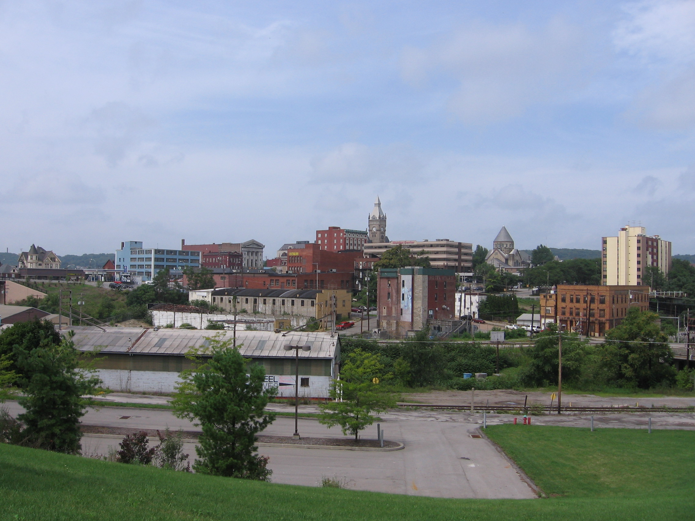 The downtown Butler, Pennsylvania skyline over a disused rail yard, courthouse clock tower rising above red-brick storefronts, 2015