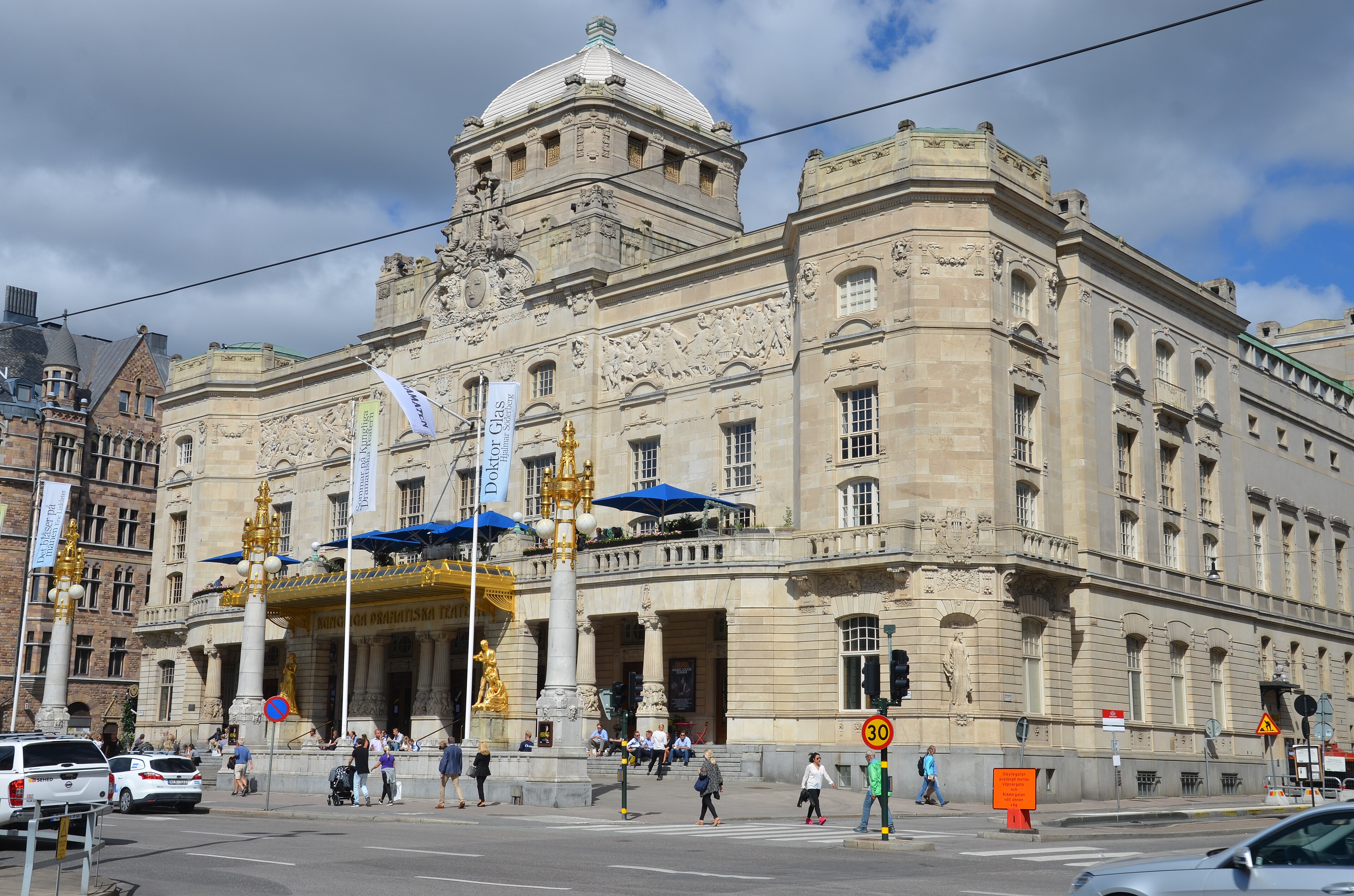 The Royal Dramatic Theatre in Stockholm, an ornate sandstone facade with a white dome above a golden entrance canopy, 2015