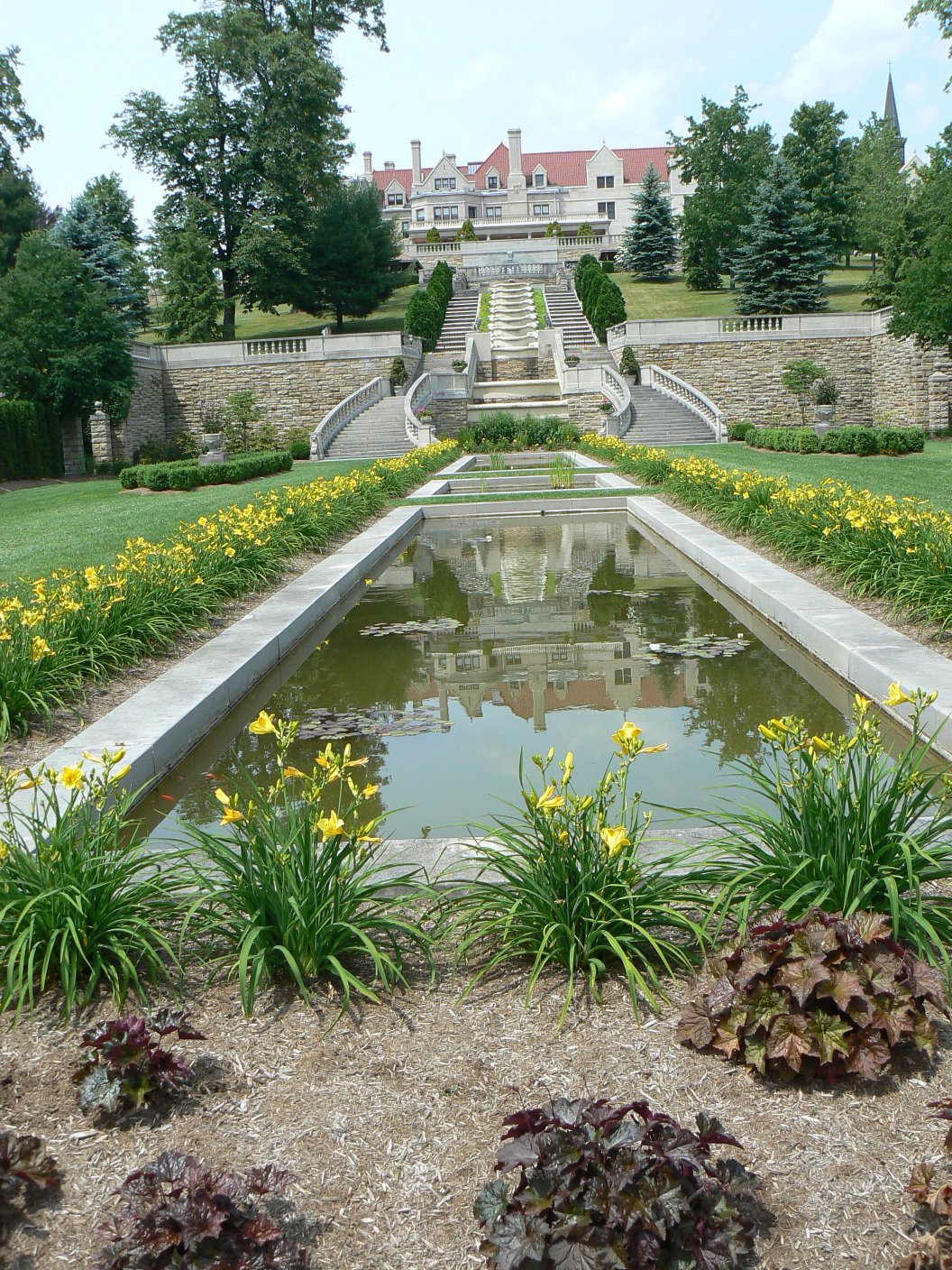 The formal terraced gardens and reflecting pools of Saint Francis University in Loretto, Pennsylvania, a slate-roofed mansion at the top of the steps, 2015