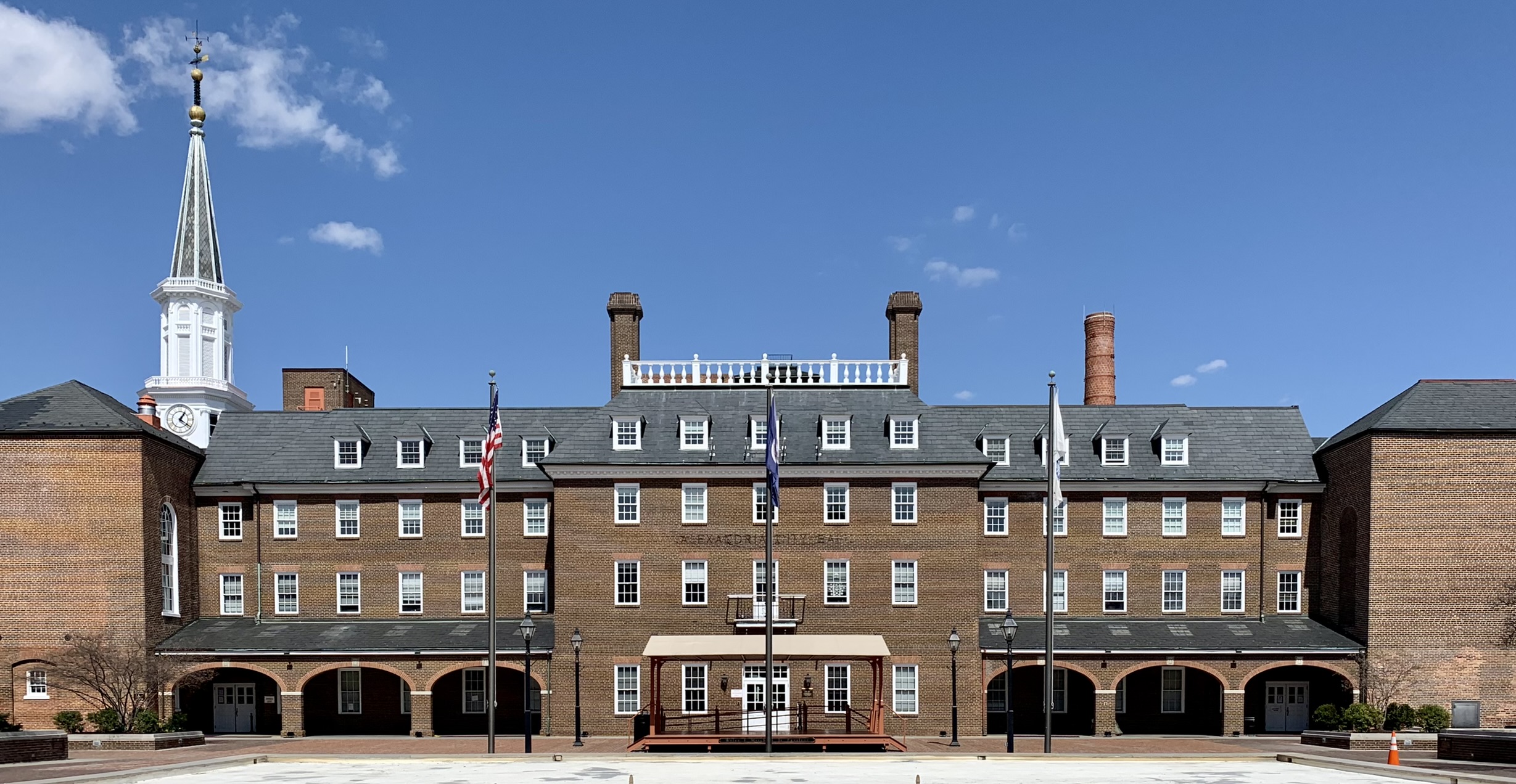 The red-brick Georgian facade of Alexandria City Hall, white cupola with weathervane above a slate mansard roof, 2015