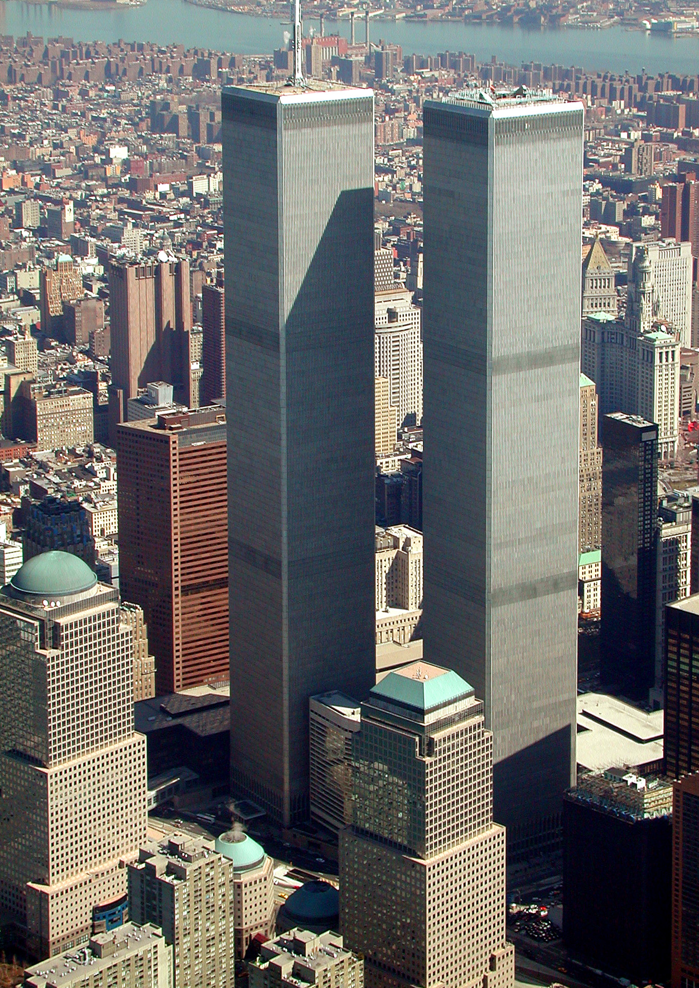 Aerial view of the Twin Towers of the World Trade Center rising over Lower Manhattan with Brooklyn across the East River, 2001