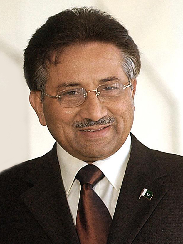 Pervez Musharraf smiling in a candid portrait, rimless glasses and a Pakistan flag lapel pin on a dark suit and burgundy tie, 2004