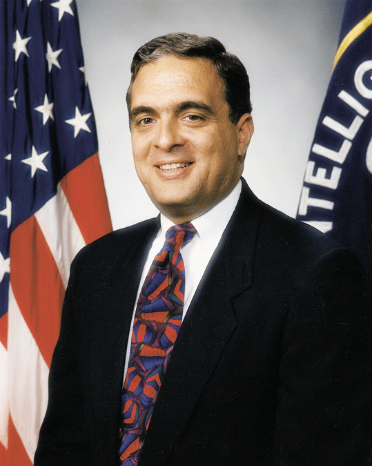 CIA director George Tenet in an official portrait with the US flag and the CIA emblem behind him, 1997
