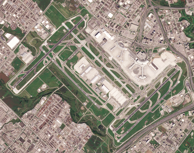 Overhead satellite view of Toronto Pearson International Airport, its terminals and runways cutting a grid through the surrounding city, 2009